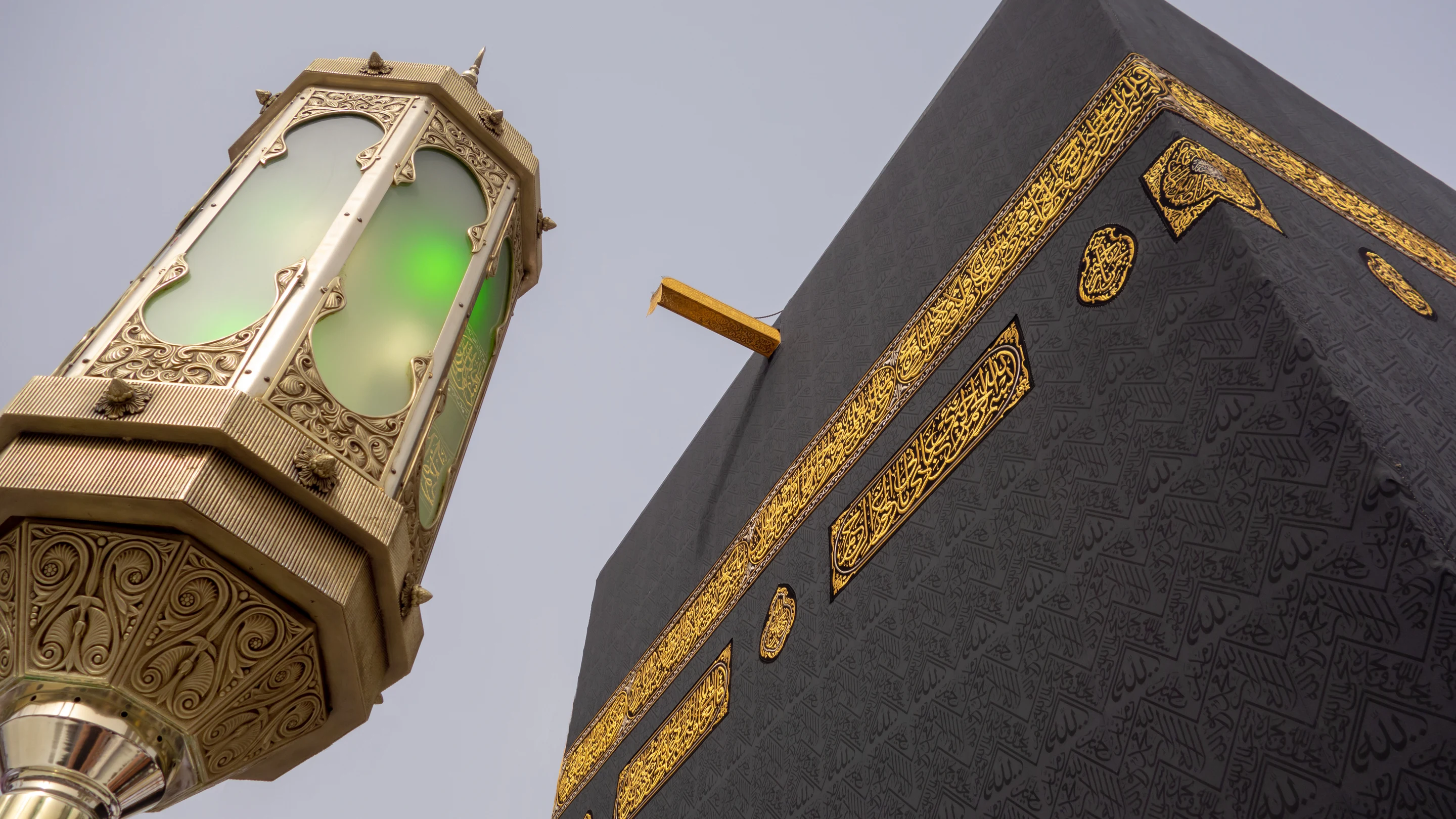 The Kaaba at Masjid al-Haram in Makkah, photographed from below against the evening sky
