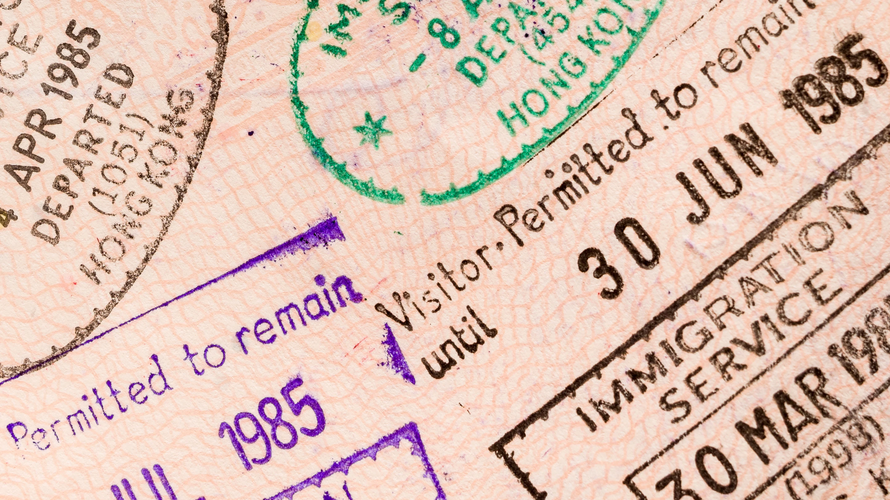 A passport and vaccination booklet laid out on a desk, ready for travel documentation